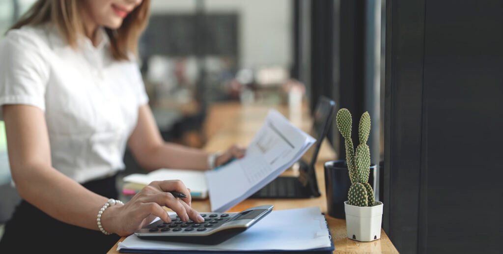 businesswoman or accountant working financial investment on calc