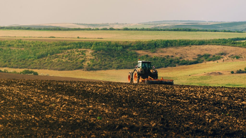 photo of tractor cultivating a land, preparation for new year