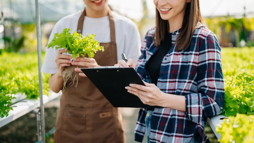 asian farmer using hand holding tablet and organic vegetables hy